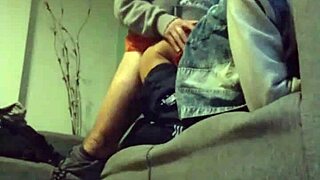 A couple relaxes on the sofa, enjoying each other's company in a casual setting.