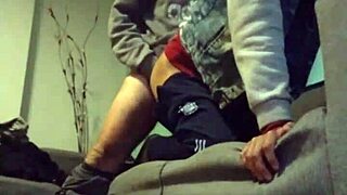 A couple relaxes on the sofa, enjoying each other's company in a casual setting.