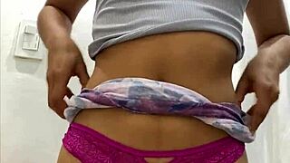 A small sized amateur girl is masturbating under her skirt