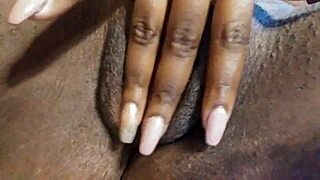 Ebony babe fingers her wet pussy close up