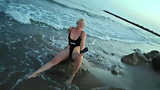 Blonde shows tits and sucks cock on a public beach