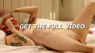 The cute girl next door with long pink hair wears a straight-jacket in this close up