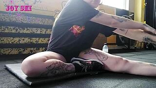 alternative girl stretching at the gym