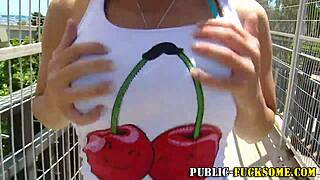 Busty blonde amateur flashes her big tits in a bikini outdoors in public.