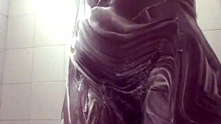 Amateur pornstar masturbates in soapy shower costume