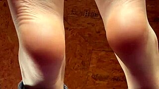 girl puts lotion on feet in fetish video