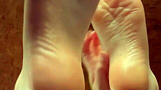 girl puts lotion on feet in fetish video