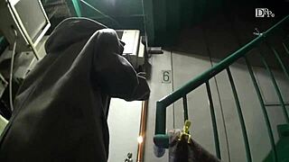 Asian girl walks night alley with remote vibrator attached.