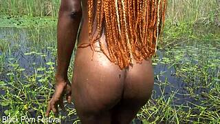Slim African Woman Bathes In River