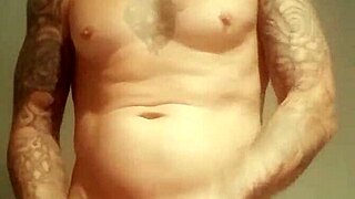 Amateur guy with blue eyes flashes his big cock in a public shower after lockup.