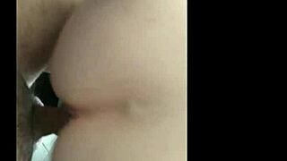 the milf rides the brown cock in a homemade interracial scene featuring big natural tits and passionate riding