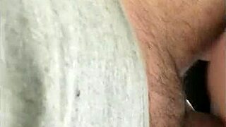 the milf rides the brown cock in a homemade interracial scene featuring big natural tits and passionate riding