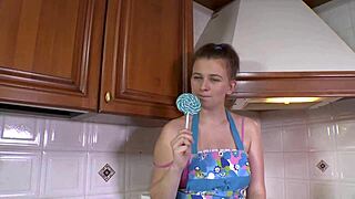 Brunette enjoys sucking on a lollipop while wearing high heels.