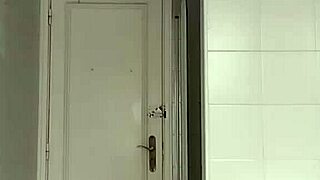 sexy guy casually shaving in black beach shorts