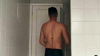 sexy guy casually shaving in black beach shorts