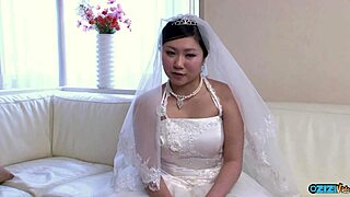 The new Asian wife, still in her wedding gown, gets a visit