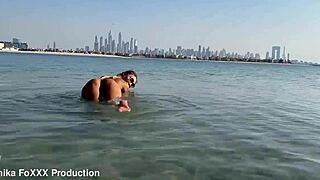 monika fox swims naked in the sea and walks along the beach freely.