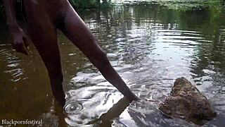 Attractive african village girl bathing in the river under the sun