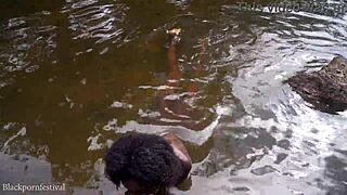 Attractive african village girl bathing in the river under the sun