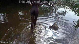 Attractive african village girl bathing in the river under the sun
