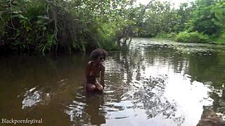 Attractive african village girl bathing in the river under the sun