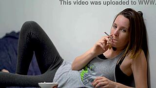 Brunette babe teases while smoking outdoors