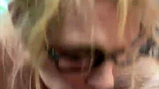 a woman with glasses on the street chats with a man casually