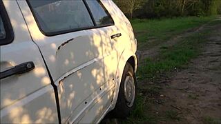 Young girl handles breakdown next to old car