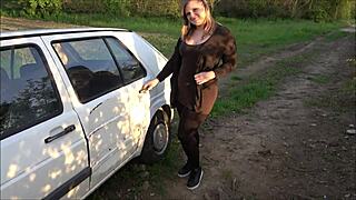 Young girl handles breakdown next to old car