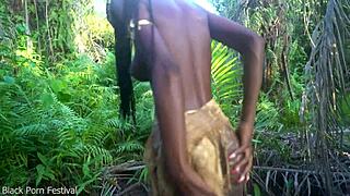 dark skinned african beauty dances seductively half naked in village forest showing perfect curves