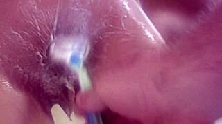 Shaving smooth pussy clean during steamy bath routine