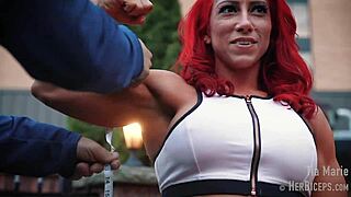tia marie flexes her muscular biceps while showing off sexy redhead body in tape