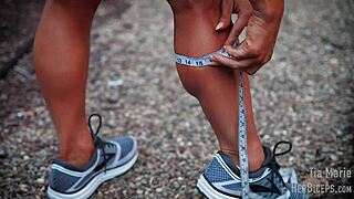 tia marie flexes her muscular biceps while showing off sexy redhead body in tape