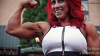 tia marie flexes her muscular biceps while showing off sexy redhead body in tape