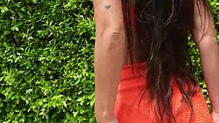 sexy babe flashes orange bikini in public outdoors