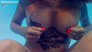 melissa the tattooed milf with brown eyes swims naked in her pool