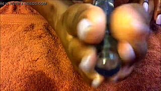 Sexfeene massages oily feet using glowing dildo tease