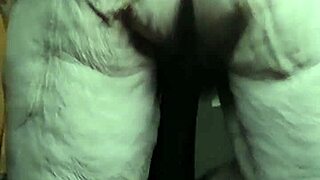 Granny Oma rams cucumber into hairy wet pussy