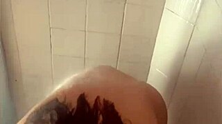 Curvy babe flashes her big ass while showering in the bath