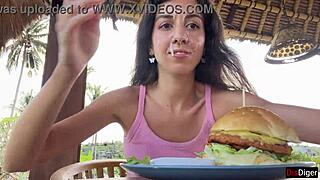 cute brunette teen eats burger cum-covered face flashing tits public cafe
