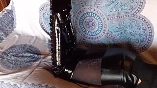 damn she's rockin' total black latex with fishnets pantyhose and knee boots