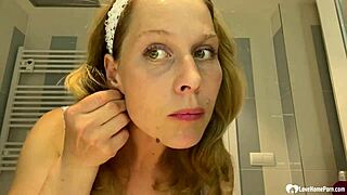 The mom next door strips teasing her big fake tits slowly