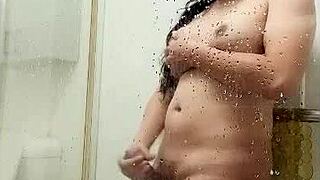See this Asian ladyboy grind her huge cock against shower glass