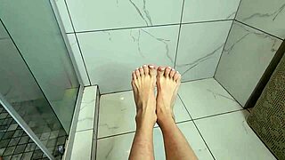 She's stroking my cock with feet in morning shower