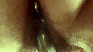 hairy pussy slowly takes glass dildo deep up close