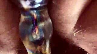 hairy pussy slowly takes glass dildo deep up close