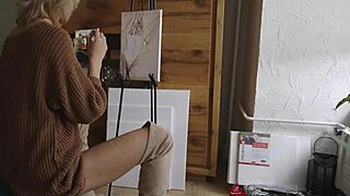 Blonde babe in boots and glasses paints her pretty pussy flower closeup