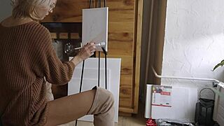 Blonde babe in boots and glasses paints her pretty pussy flower closeup