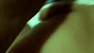 A beautiful woman teases from bed edge in white bra showing huge buttocks under blue sky