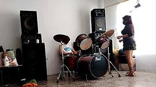 They drum while she dances, stripping her clothes and shaking that big curvy ass.